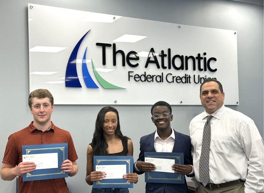 Anthony Mero, Chief Executive Officer at The Atlantic Federal Credit Union presents scholarships to three local college-bound students in The Atlantic's annual scholarship program.