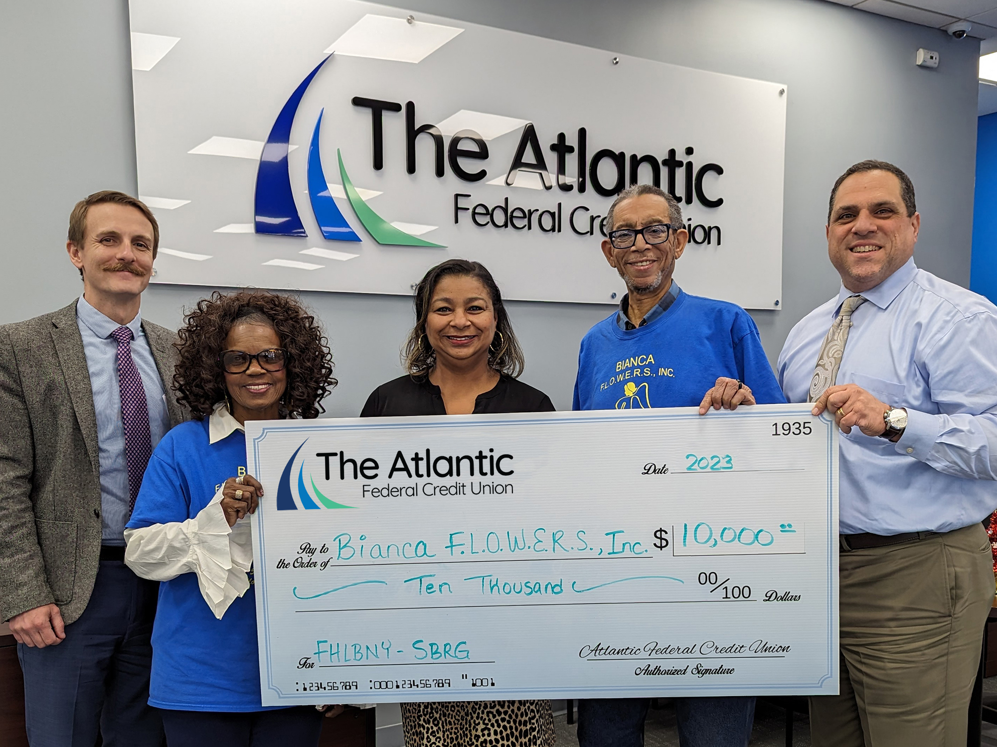 Photo of representatives from Bianca F.L.O.W.E.R.S. accepting an oversized check of $10,000 through the FHLBNY SBRG from representatives of The Atlantic