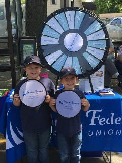 boys in front of prize wheel