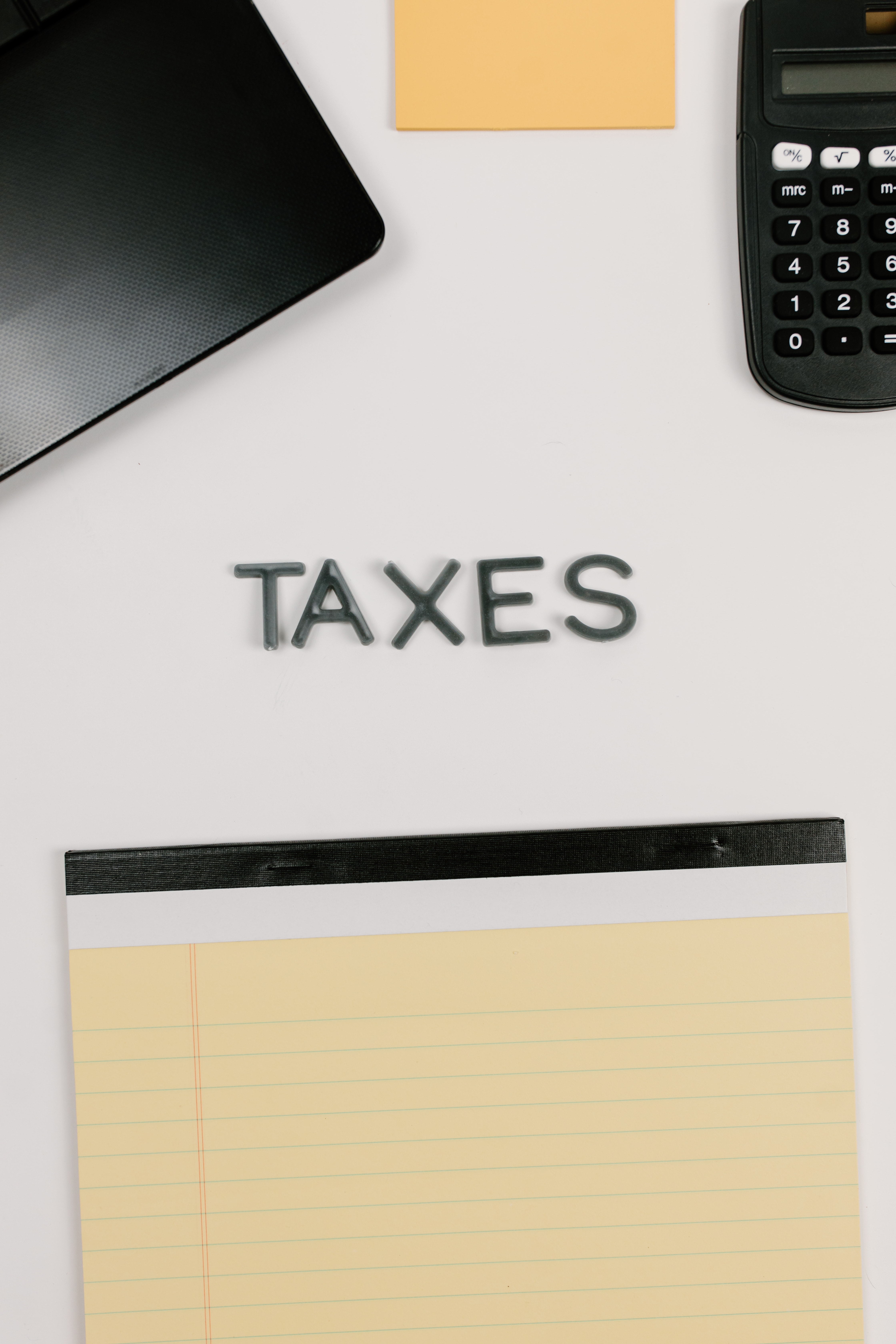 Photo of letters spelling taxes on desk