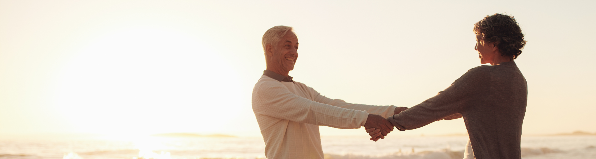 Two people enjoying retirement on the beach